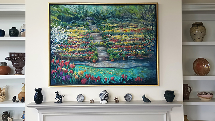 a mantel and shelves, with a painting of a colorful landscape in the center