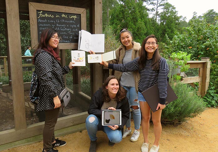 College students enjoy an art activity at the chicken coop