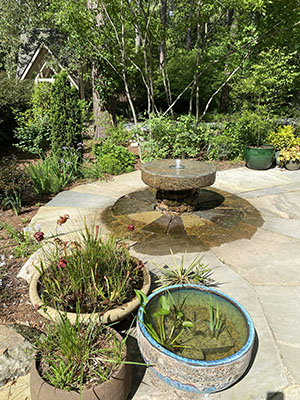 A new fountain made of millstones surrounded by a stone patio